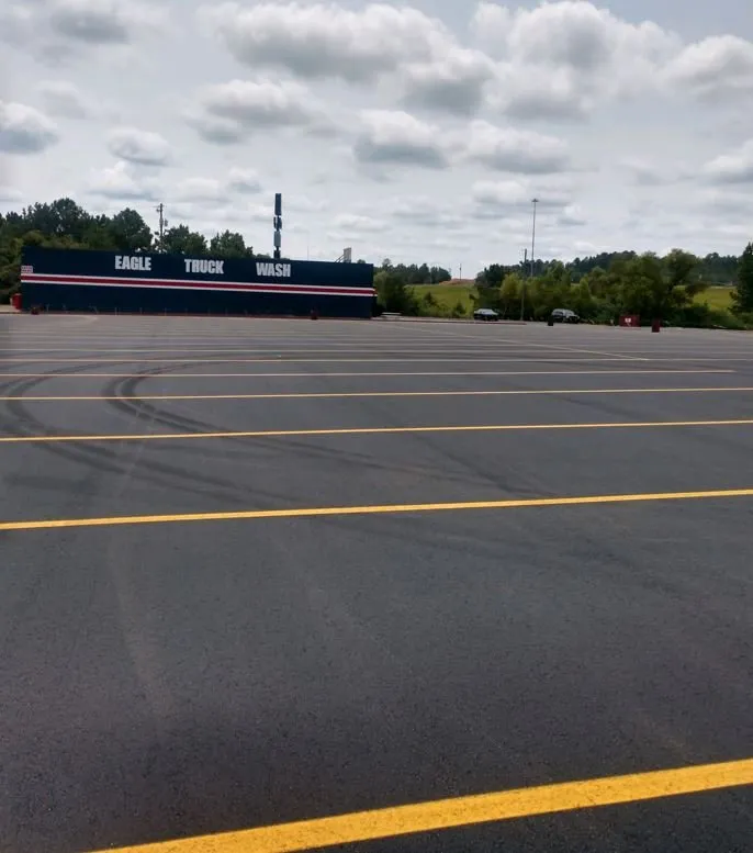 semi truck parking lot with yellow striping, newly finished asphalt