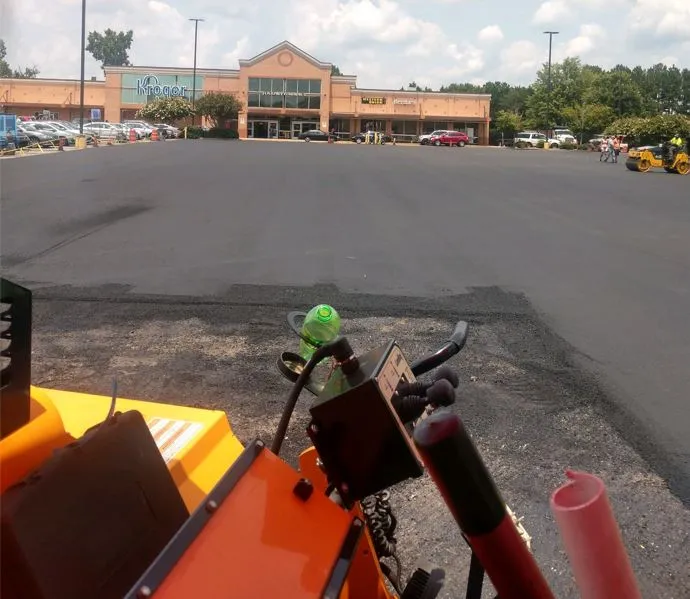 parking lot paving in progress, picture taken from inside the seat of a steamroller